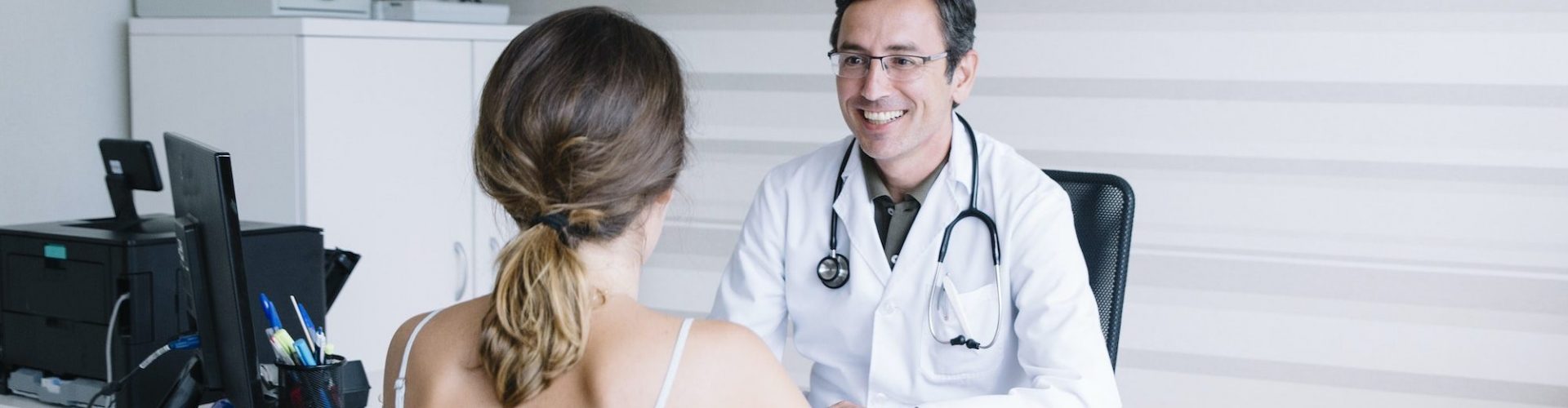 Male doctor with female patient